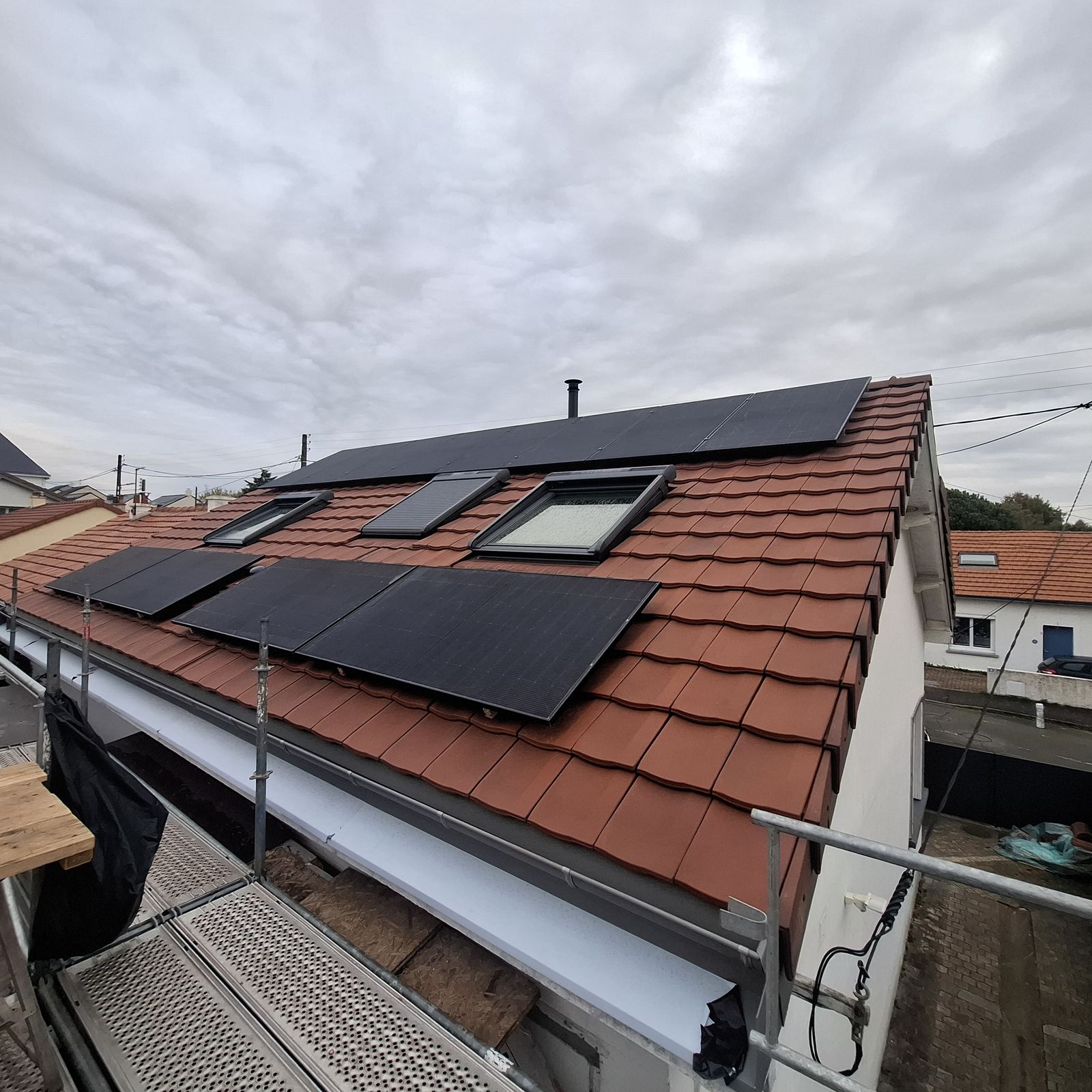 Chantier OTBE à Carquefou : toiture en tuiles et panneaux solaires posés depuis l'échafaudage
